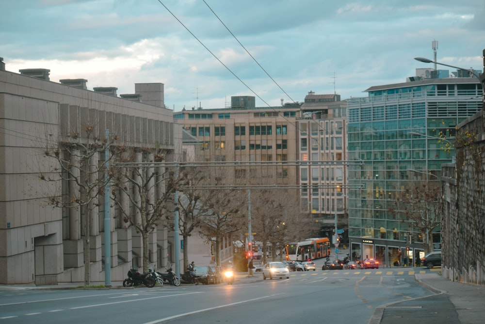 a city street filled with traffic next to tall buildings