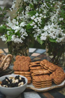 Corporate branded cookies arranged in a minimal, airy setting with subtle sage details.