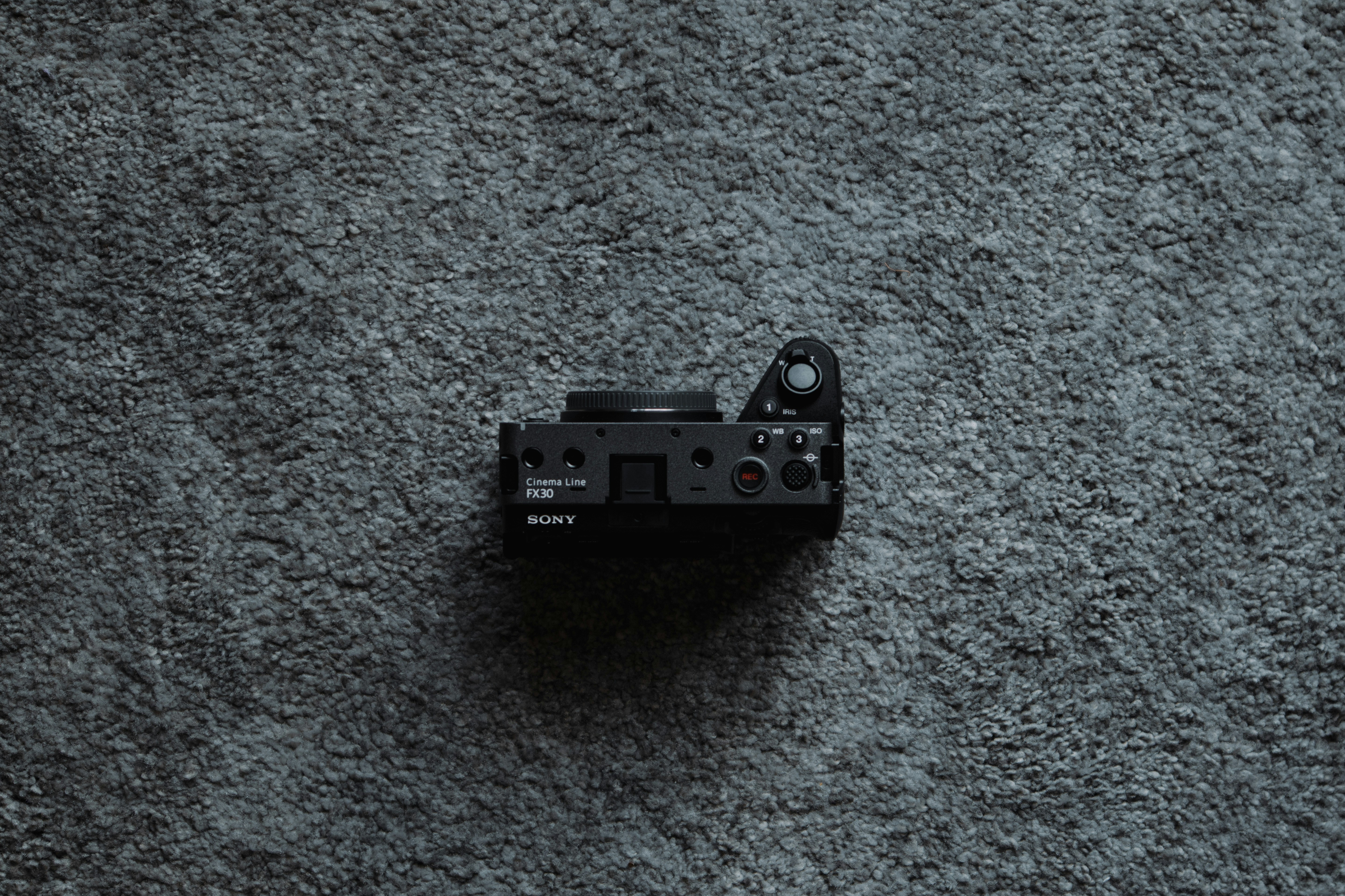 a black camera sitting on top of a gray carpet