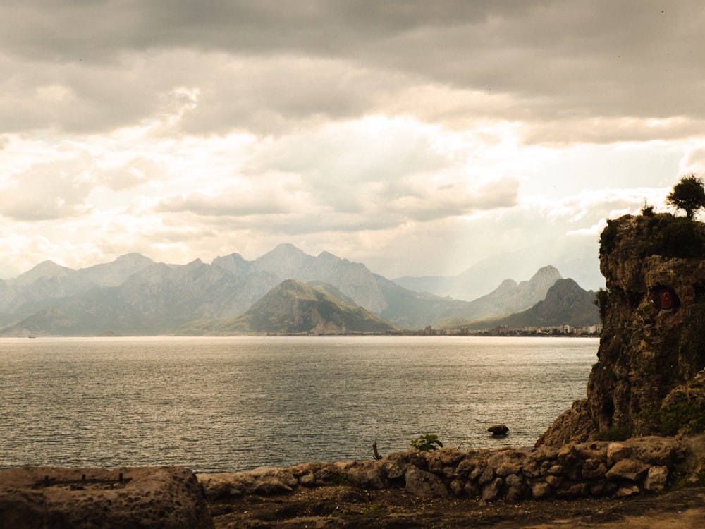 a large body of water with mountains in the background