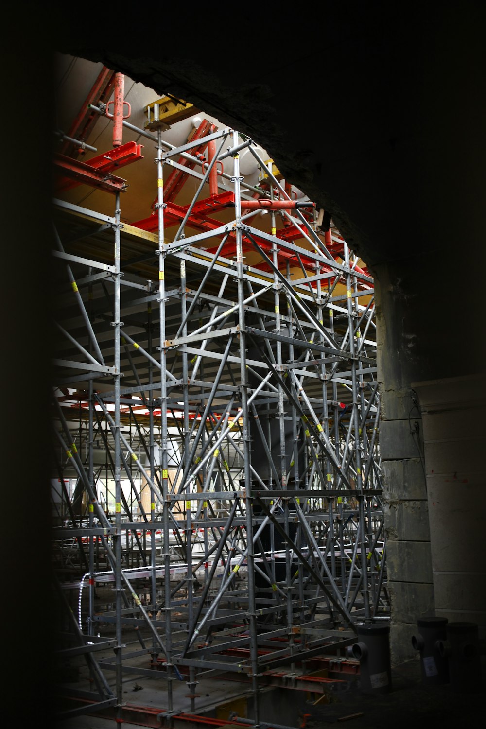 a large metal structure with scaffolding around it