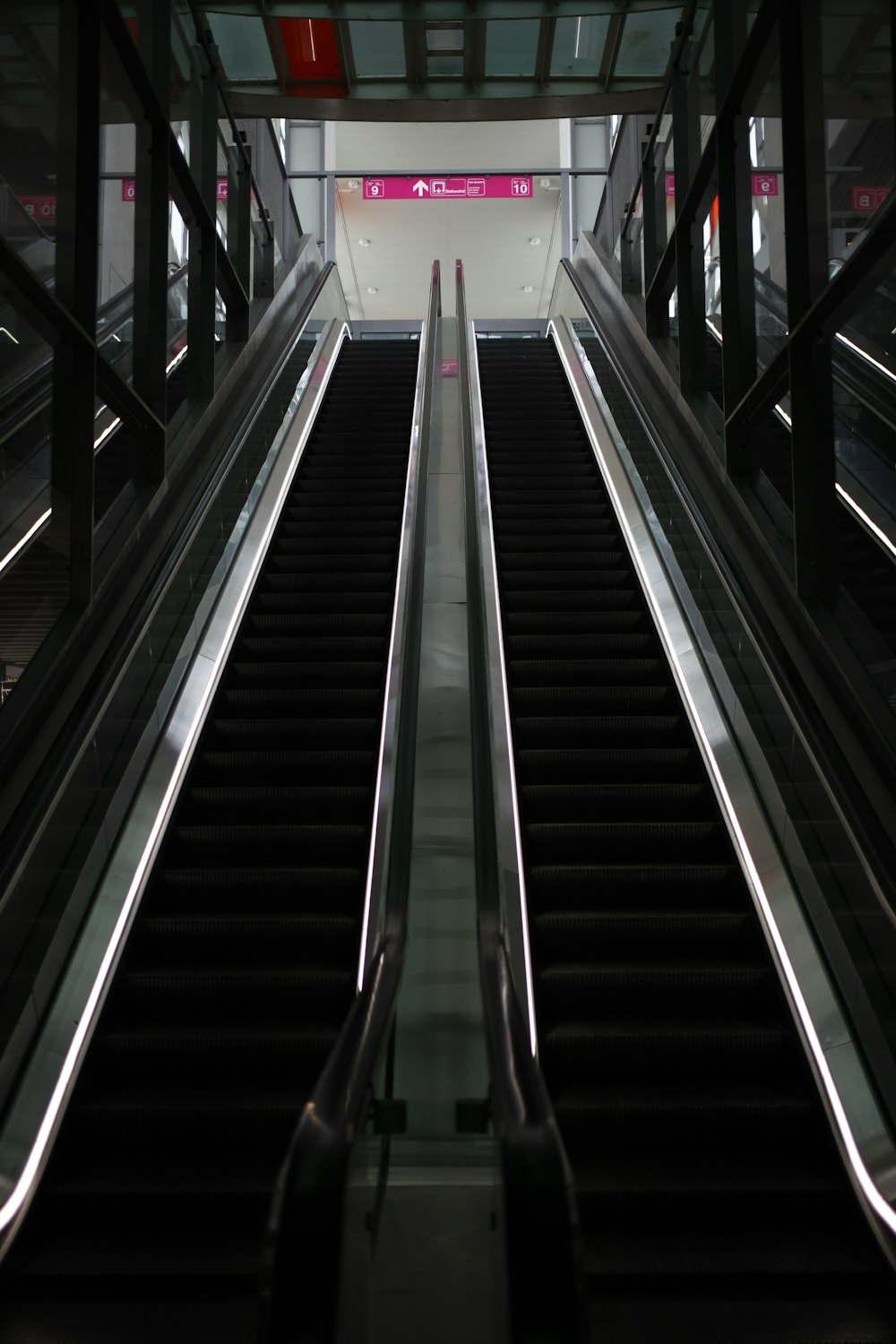 two escalators going up and down in a building