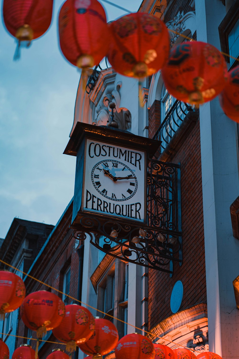 a clock hanging from the side of a building