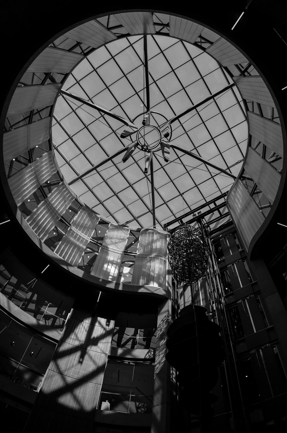 a large clock mounted to the ceiling of a building