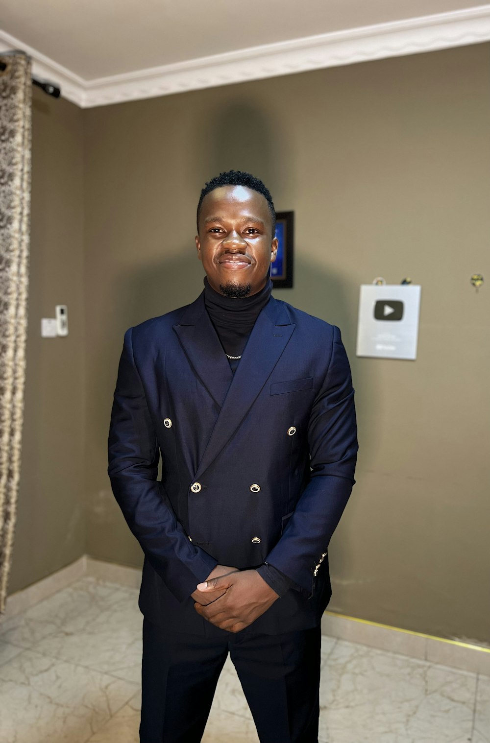 a man in a suit standing in a room