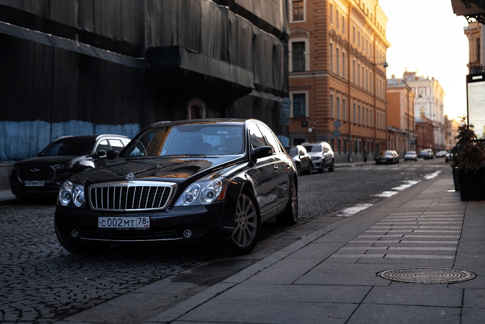 a black car parked on the side of a street