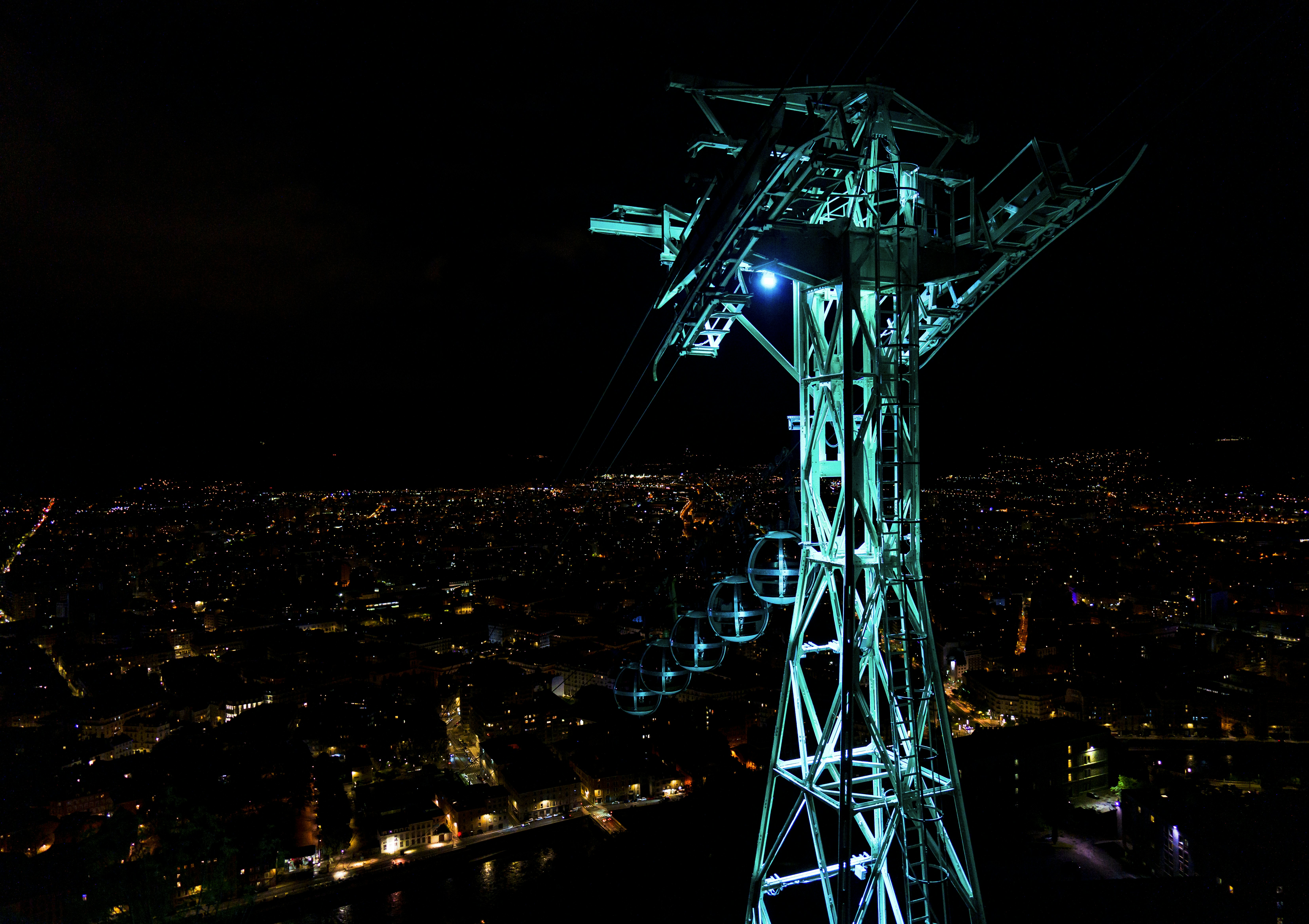 a view of a city at night from the top of a tower