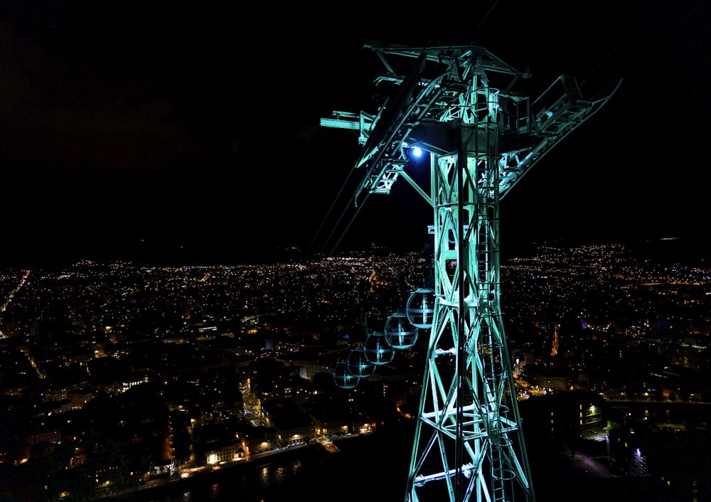 a view of a city at night from the top of a tower