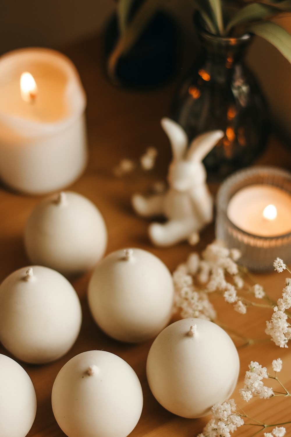 a table topped with candles and white balls