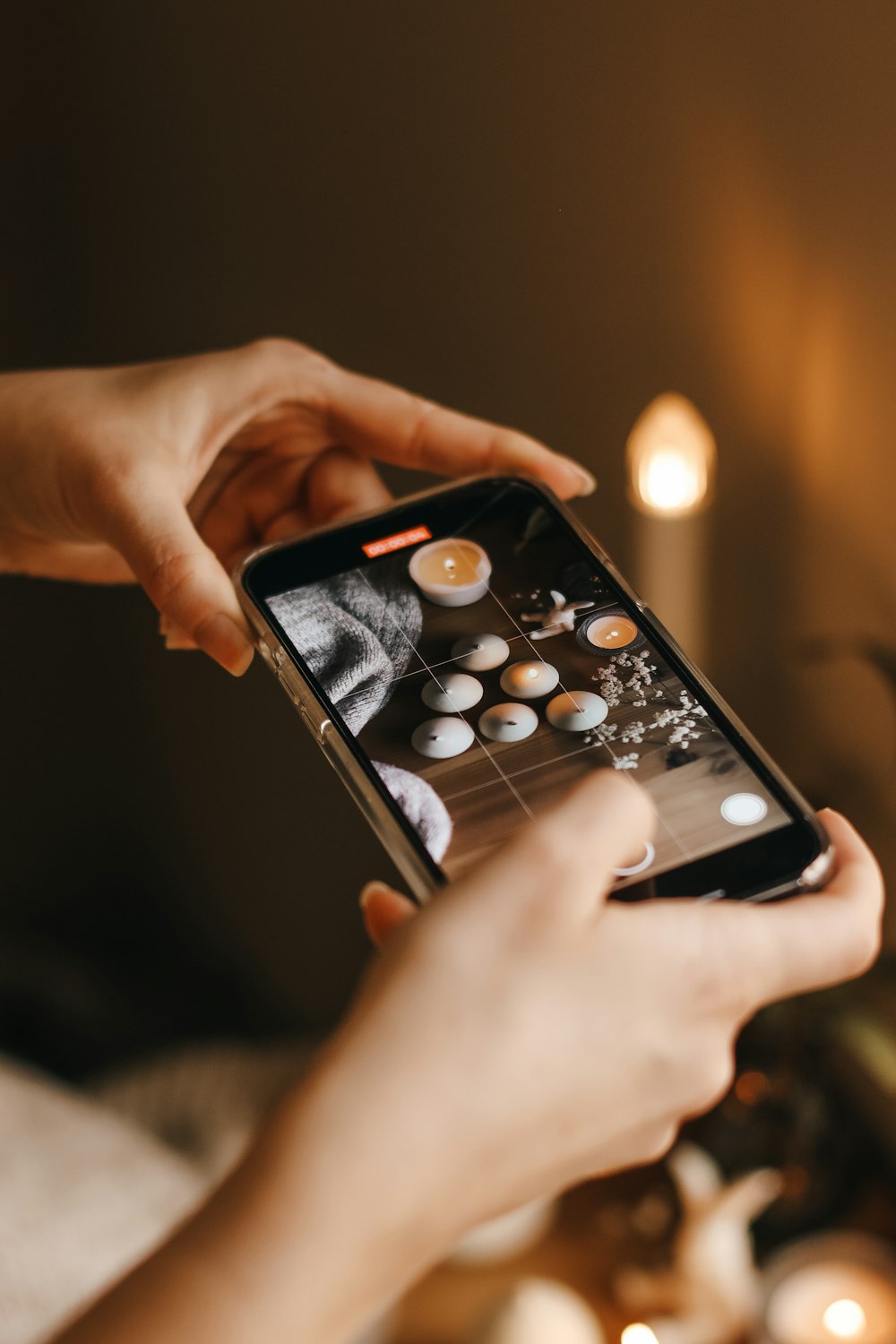 a person holding a cell phone in their hand