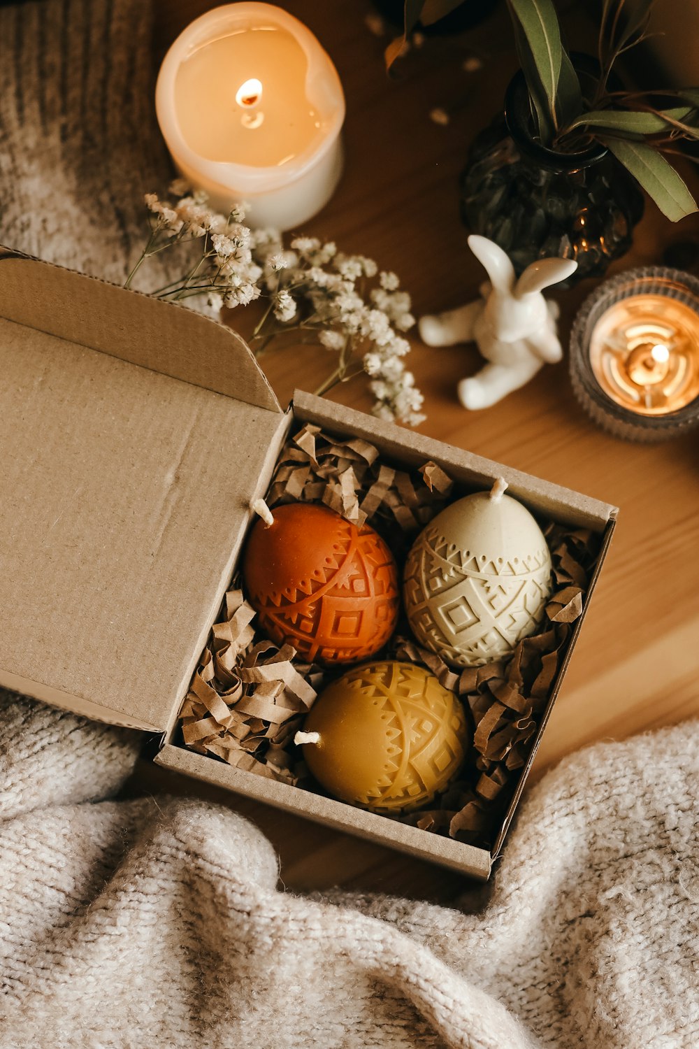a box of decorated eggs sitting on a table