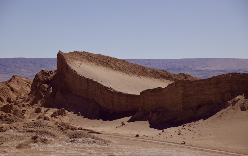 a large rock formation in the middle of a desert