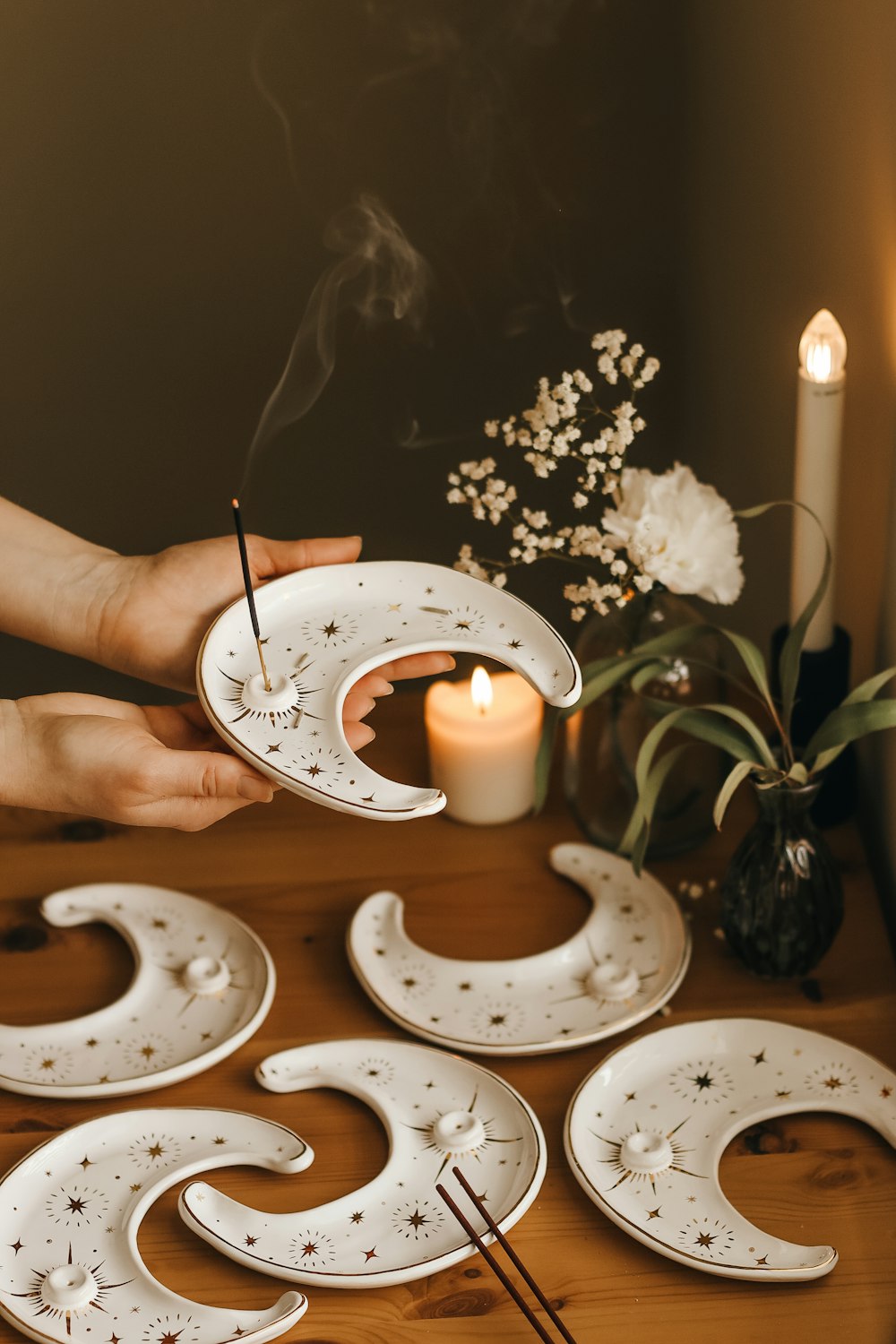 a person holding a plate with a candle on it