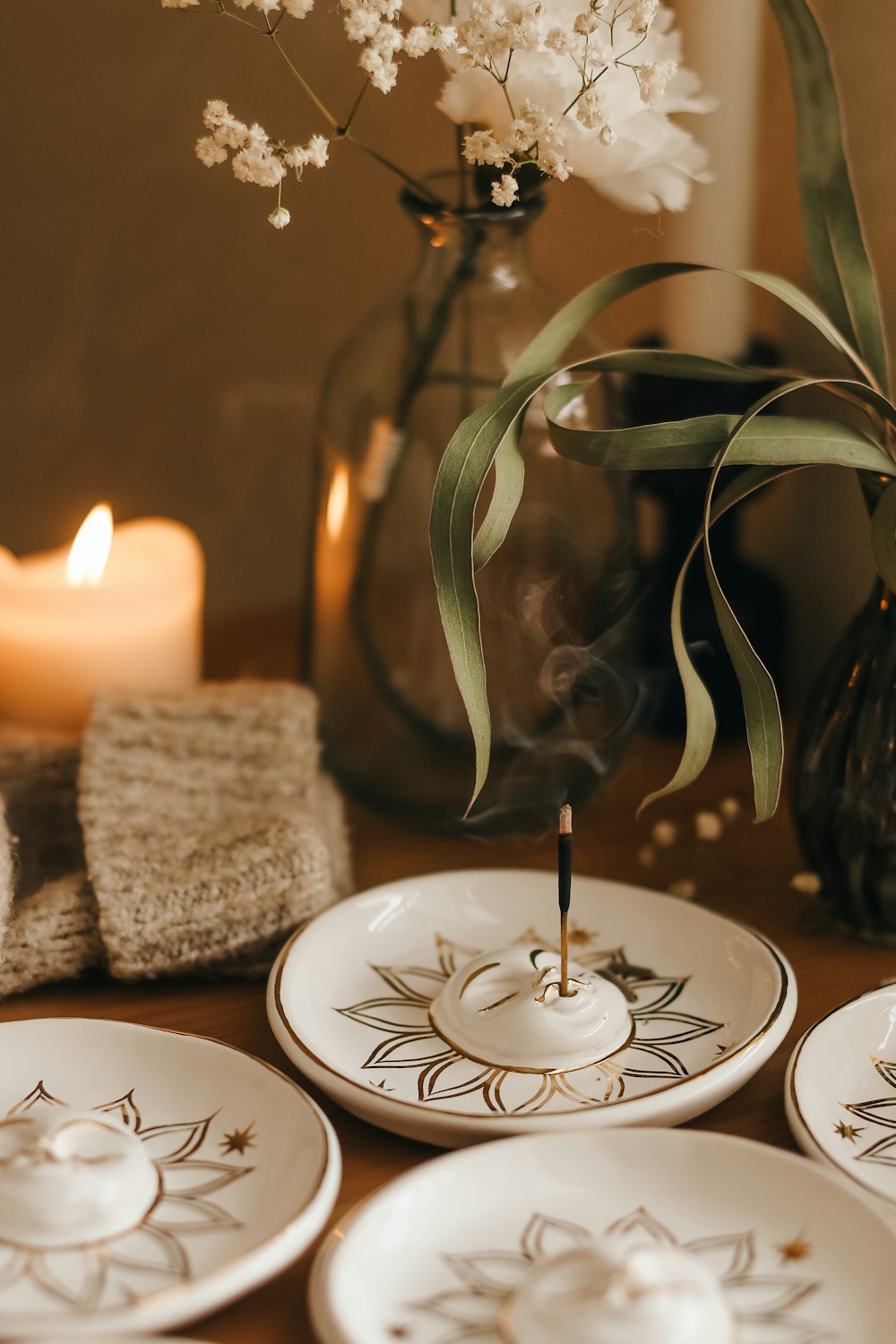 a close up of a plate with a candle in the background