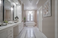 A stylish bathroom featuring elegant cabinetry and soft lighting.