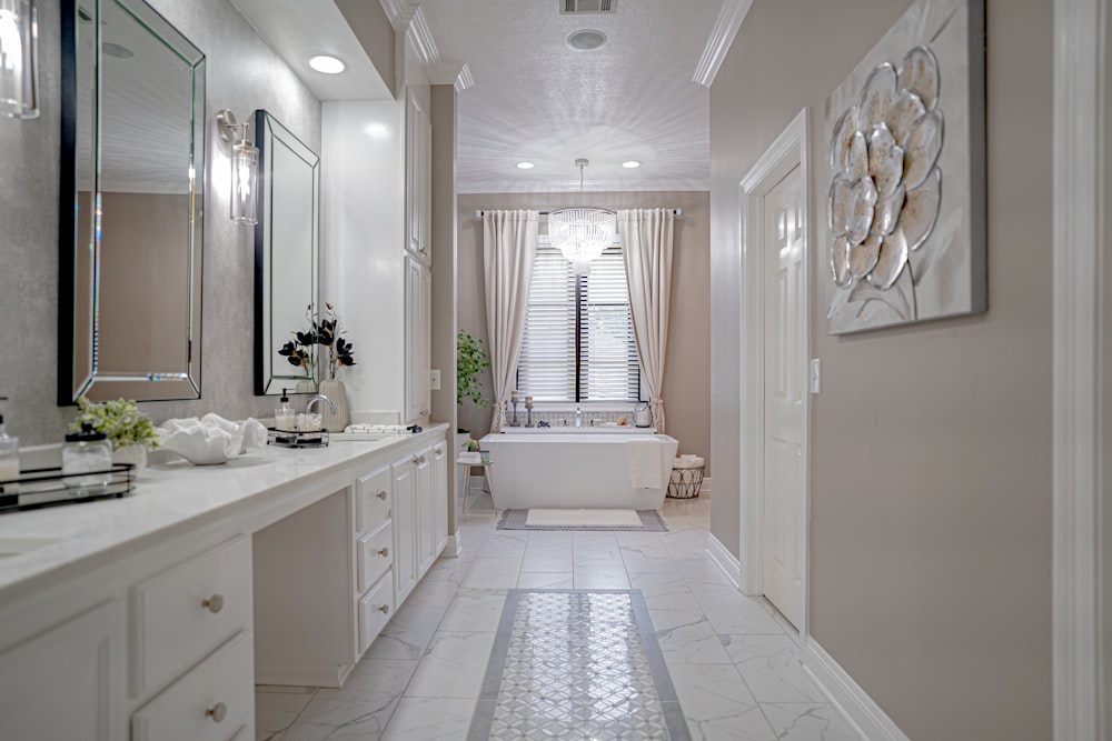 a bathroom with a tub, sink, and mirror