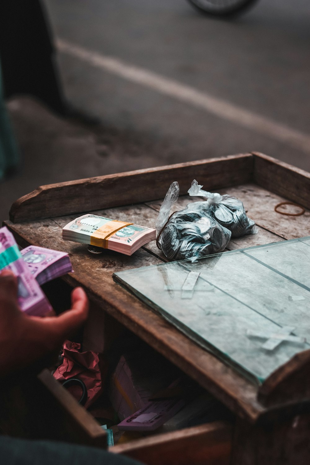 a person holding a box of money in their hand