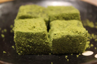 Artistic shot of matcha-flavored banana chips with a soft green powder dusting