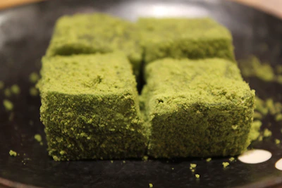 Artistic shot of matcha-flavored banana chips with a soft green powder dusting