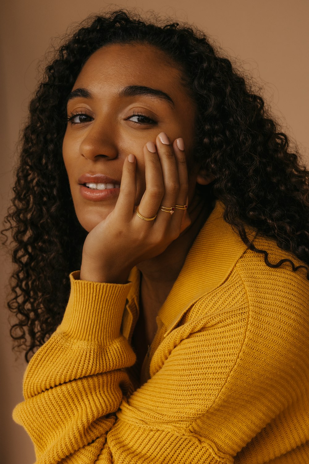 a close up of a person wearing a yellow sweater