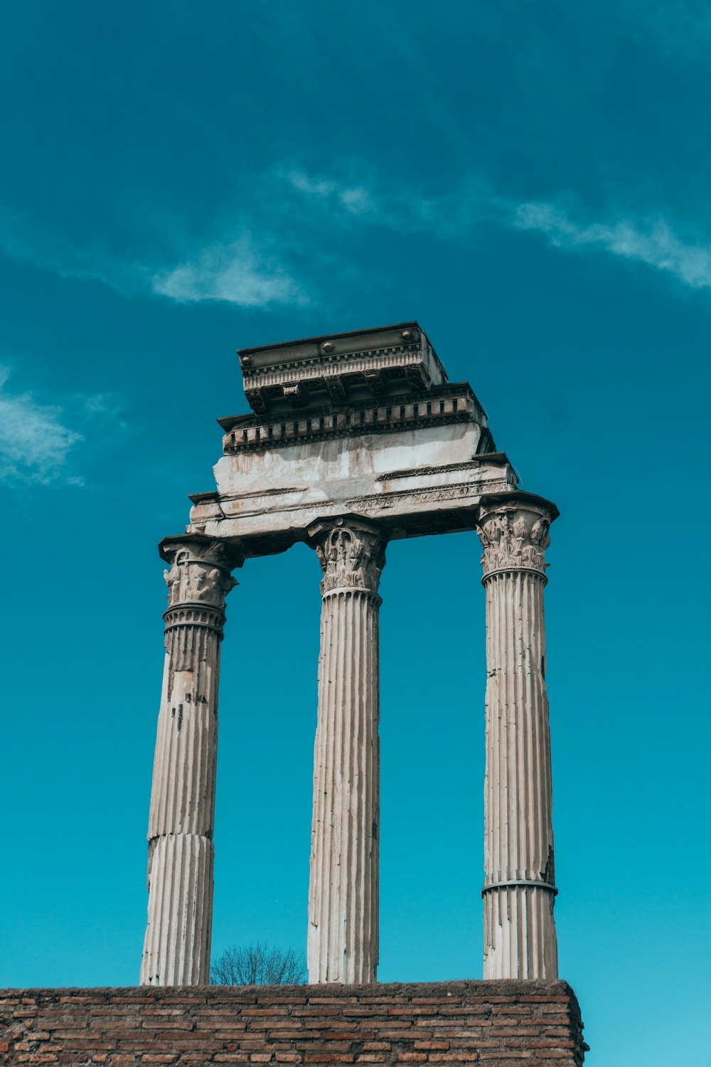 a tall stone structure with two pillars on top of it