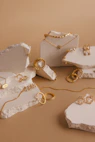 A set of copper cuffs and necklaces artfully arranged on a soft linen cloth.