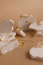 A set of copper cuffs and necklaces artfully arranged on a soft linen cloth.