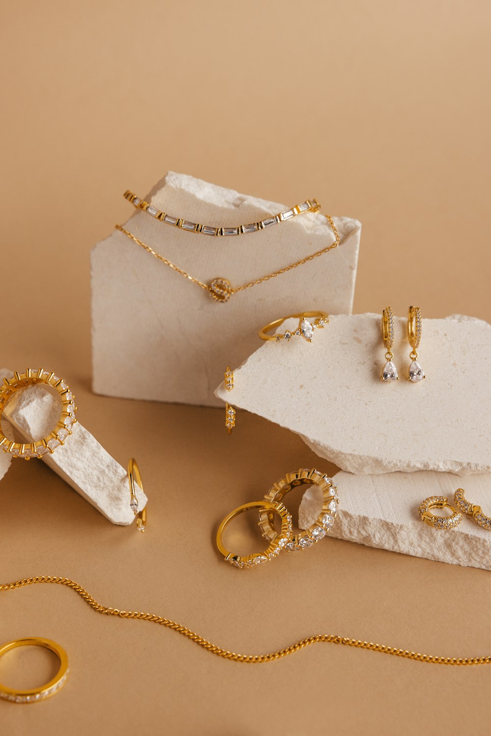 a white box with gold jewelry on it