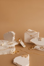 a table topped with jewelry and a piece of cake