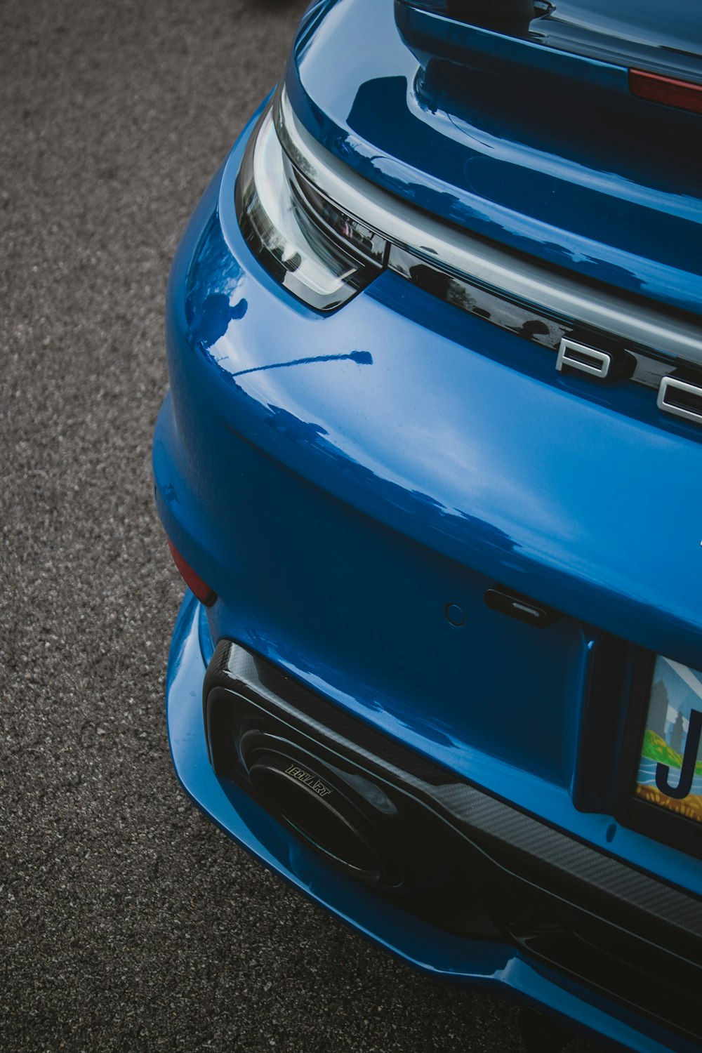 the rear end of a blue sports car