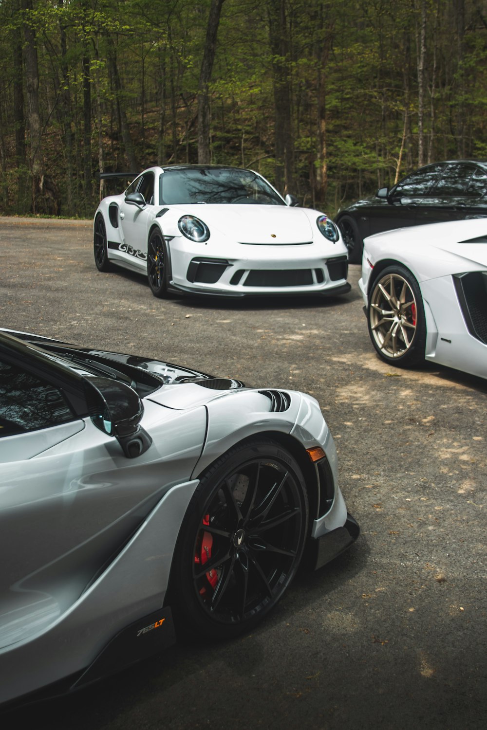 two white sports cars parked next to each other