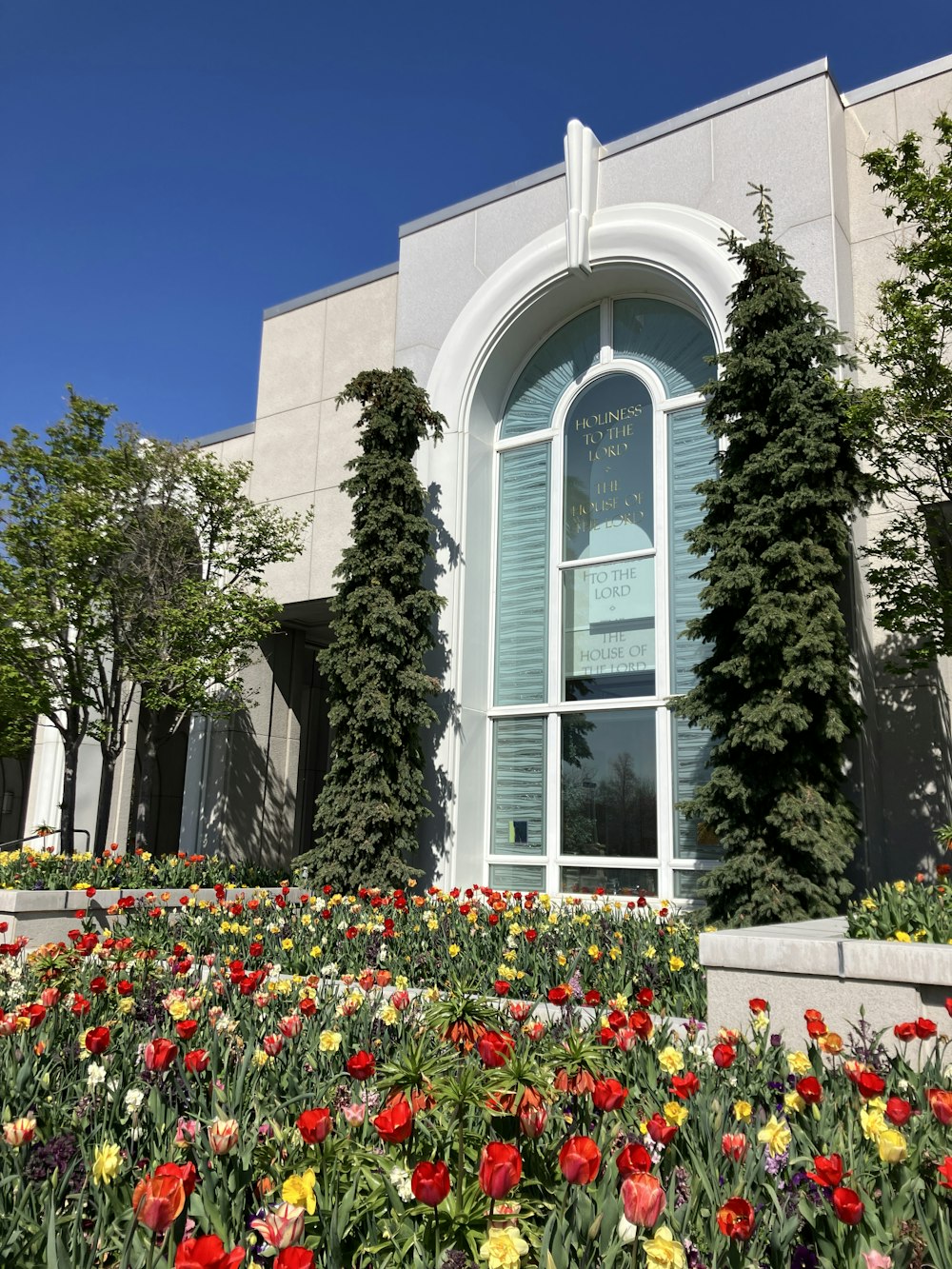 a building with a bunch of flowers in front of it