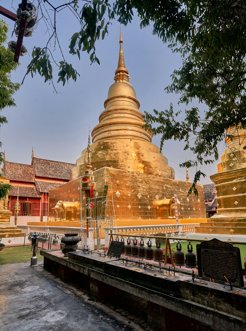 a large golden building sitting next to a lush green field