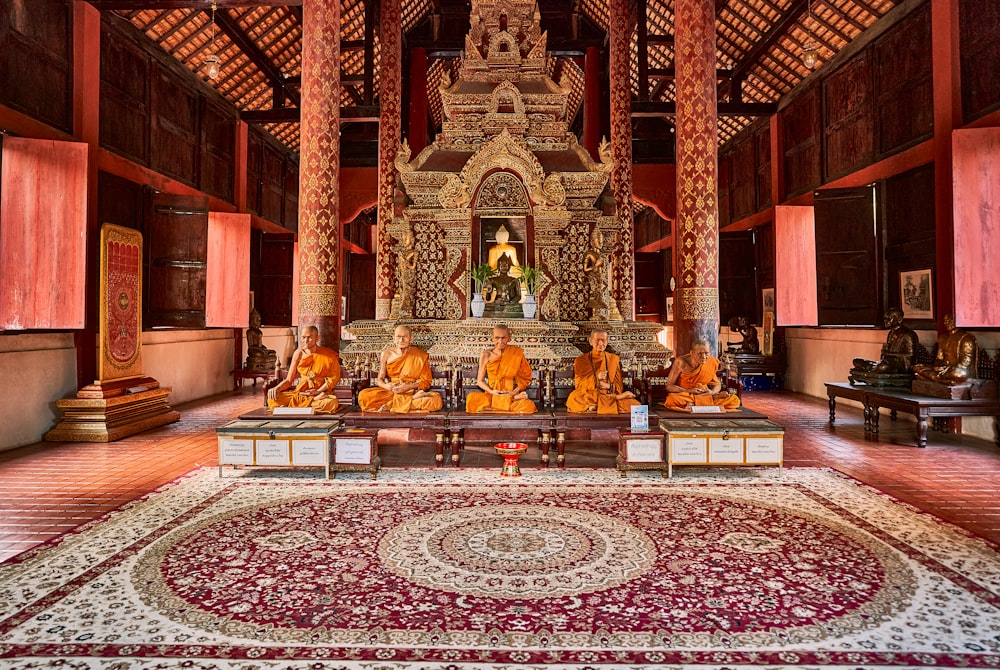 a group of buddhas sitting in a large room