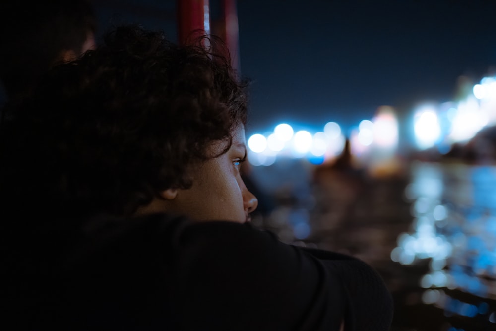 a woman looking out over a city at night