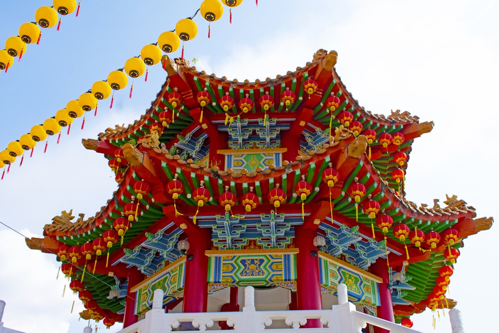 a chinese building with decorations hanging from it's roof