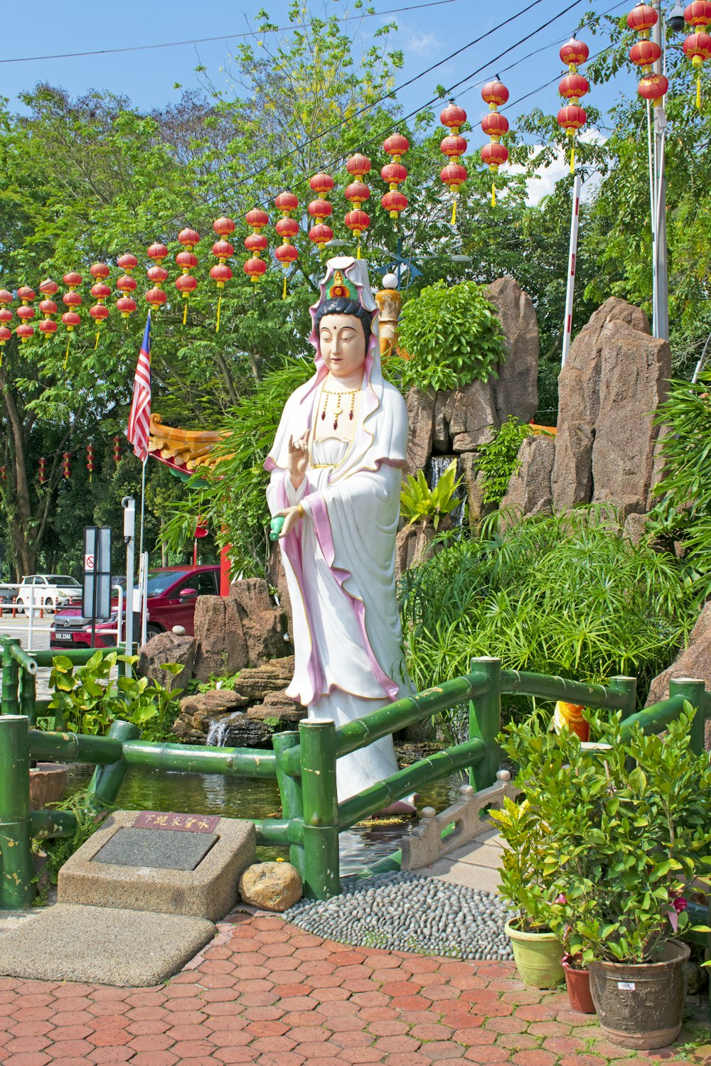 a statue of a person in a garden