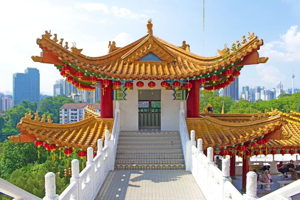 a building with a golden roof and red pillars