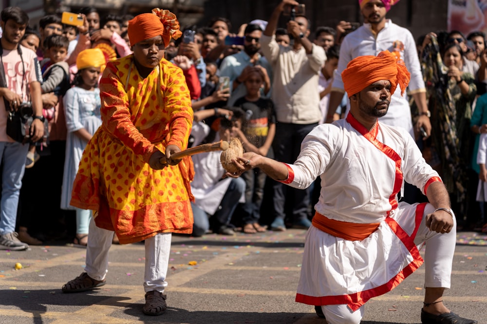a group of men in indian garb performing a dance