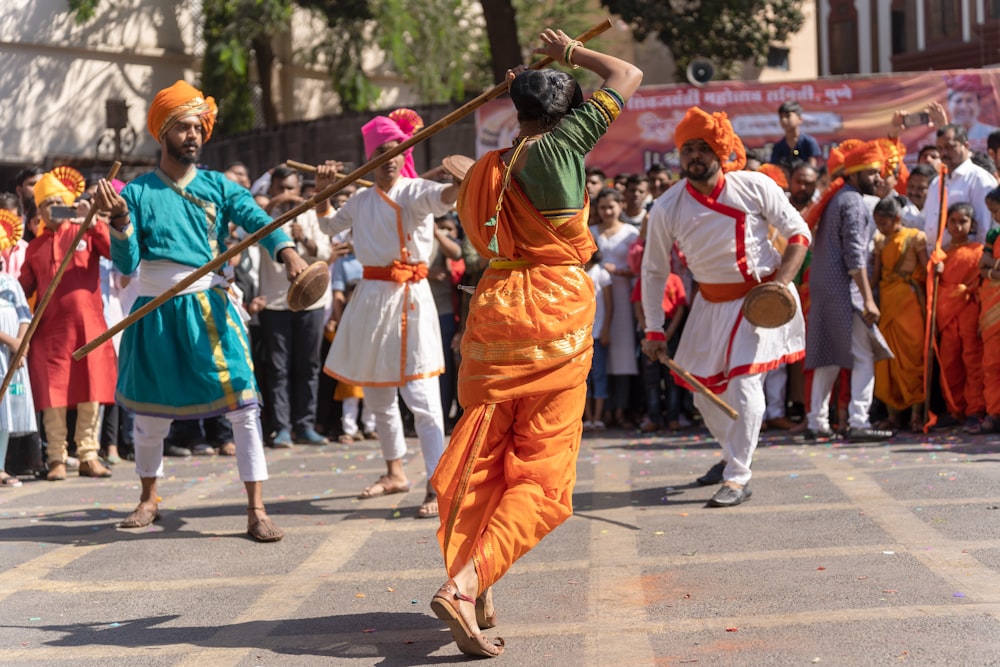 a group of people in orange and green outfits