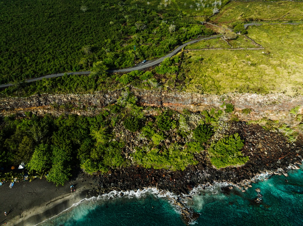 an aerial view of a winding road near the ocean