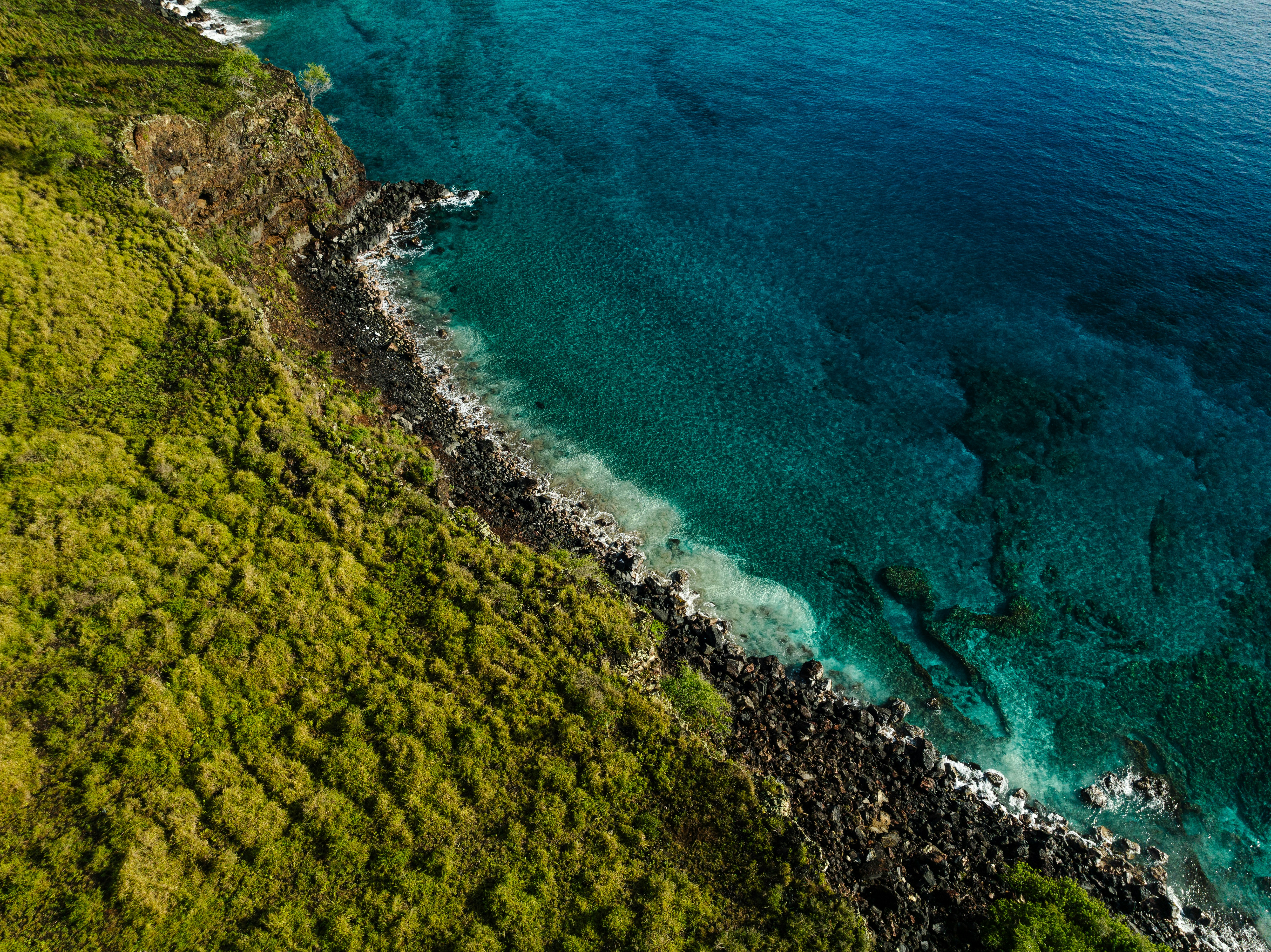an aerial view of the ocean and land