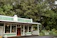 Photo of a happy small business owner standing outside their storefront in historic Green Cove Springs.