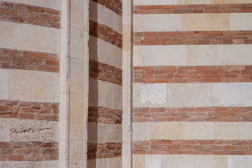 a brick wall with a clock on the side of it