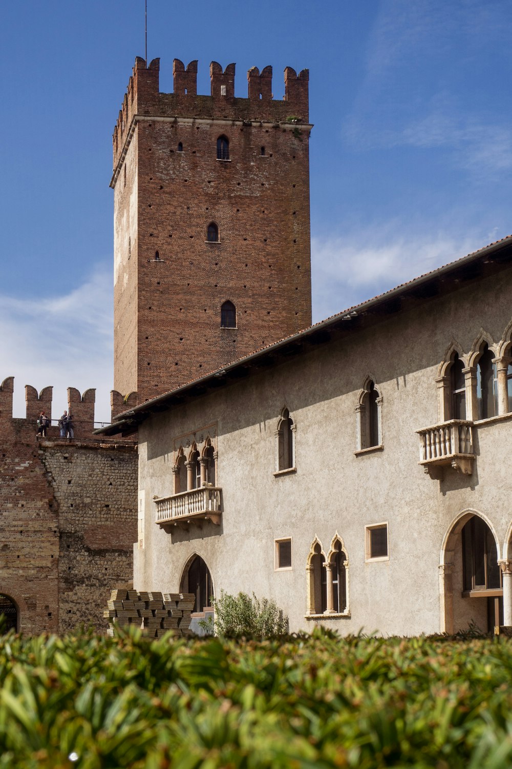 a tall brick building with a clock tower in the background