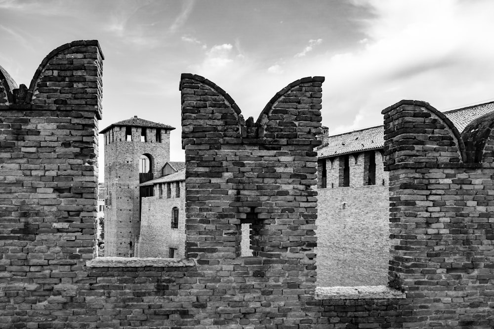 a black and white photo of a castle wall