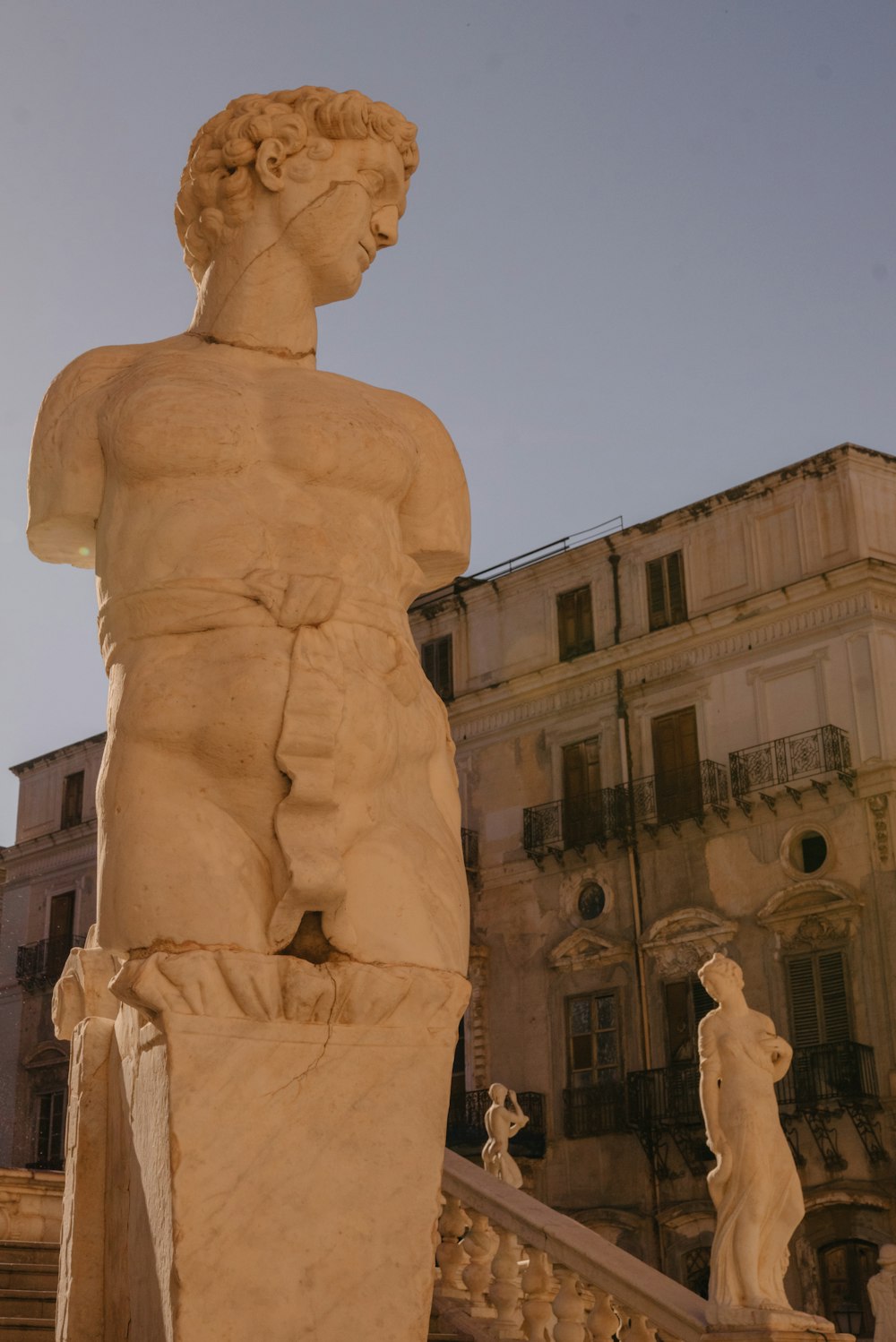 a statue of a man standing in front of a building