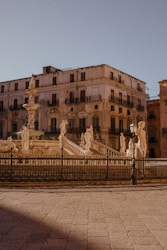 a large building with a fountain in front of it
