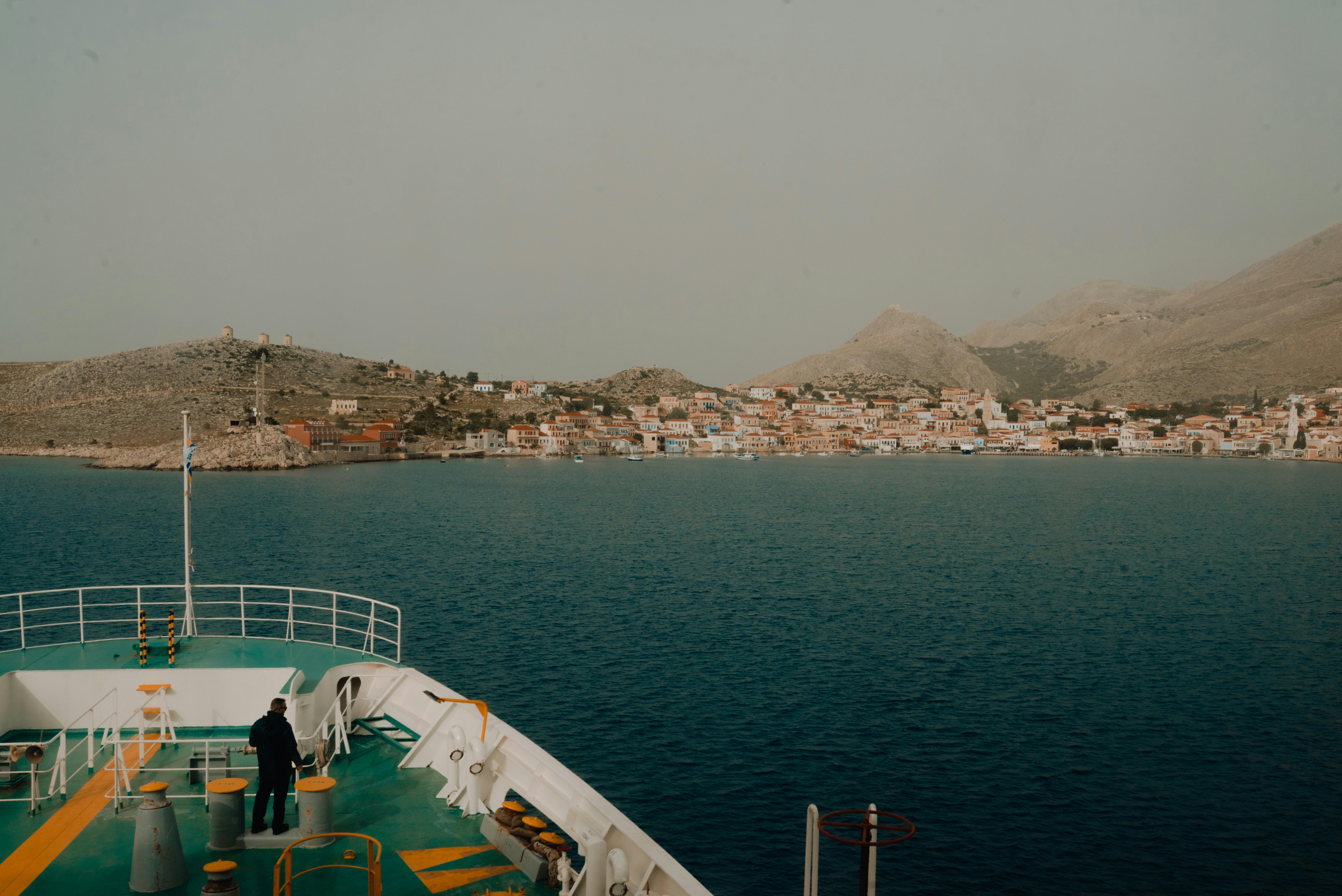 a man standing on the deck of a boat, 