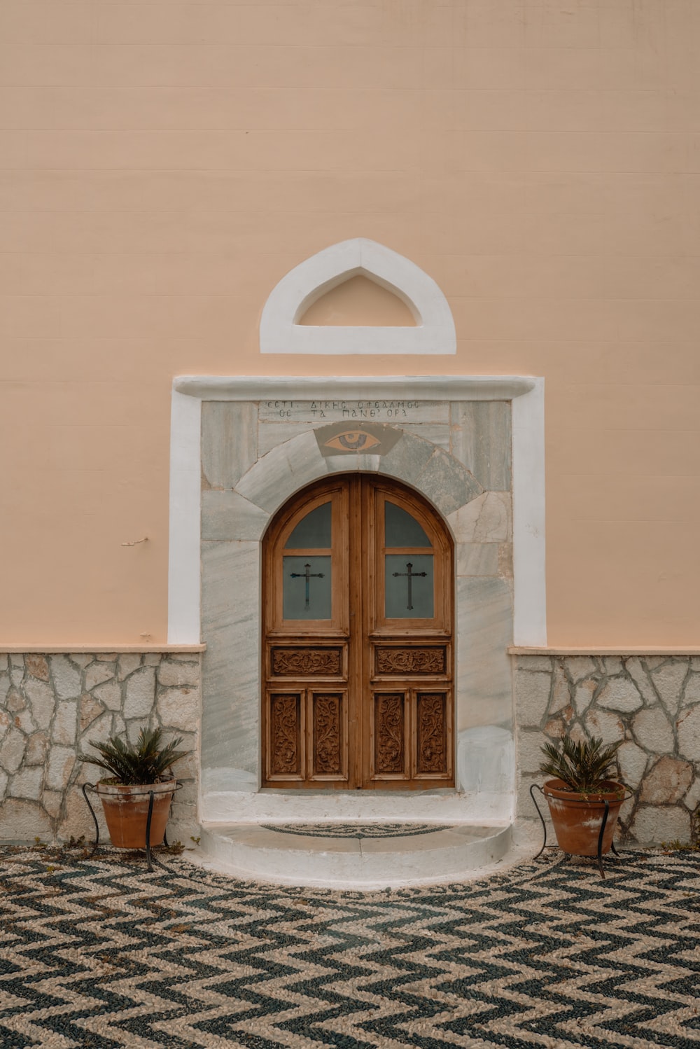 a large wooden door sitting next to a wall